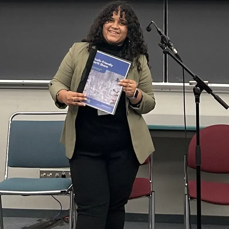 Sanchita holding the Youth-Friendly North Shore evaluation tool